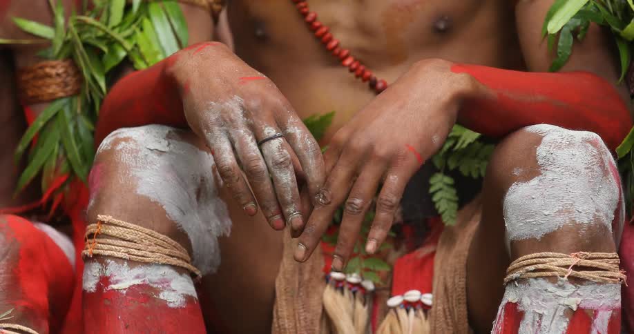 The painted legs and hands of a tribesman