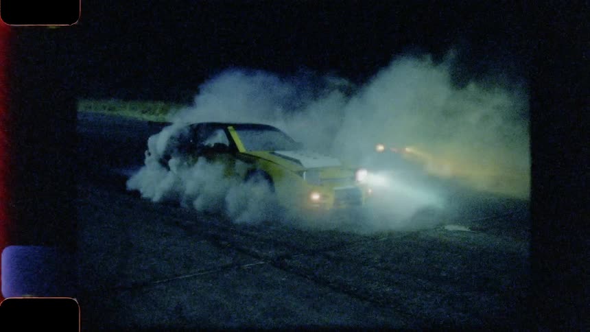 Smoke pours out of a vehicle with its tires on fire