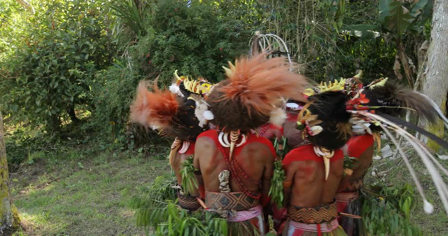 Tribe of painted men standing in a circle