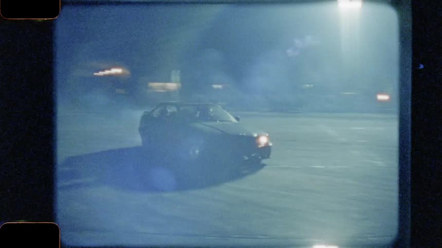 Three cars racing at night