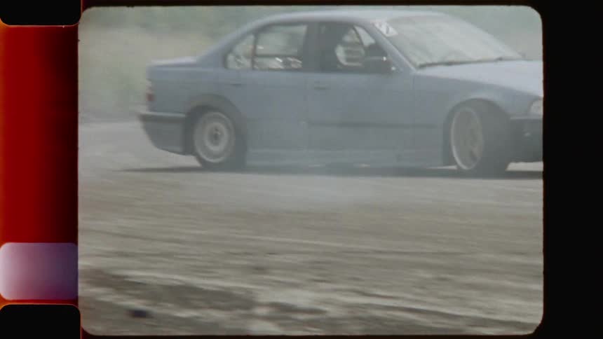 Drivers oversteer while maintaining control and driving the race cars through dirt road during daylight