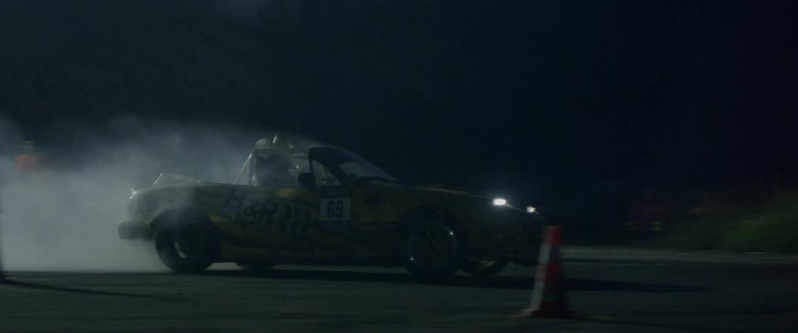 Race car leaving the race track with a smoking tire