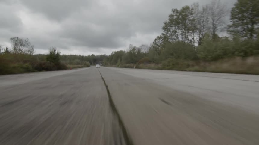 A car traveling down a road at high speed