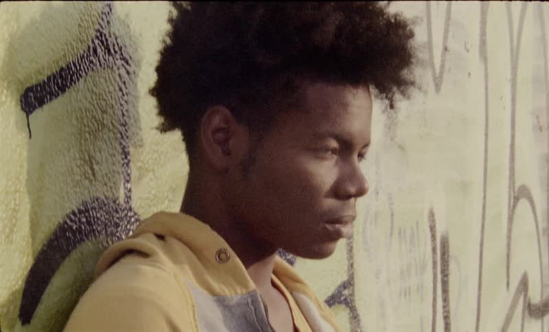Teenager leaning against a wall