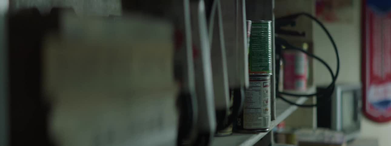 A shelving unit on a wall full of items is shaking and moving