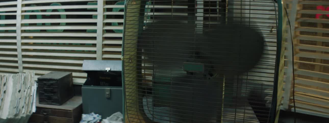 A box fan spins very roughly