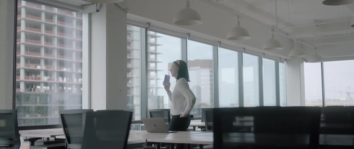 Girl talking on her phone next to a window