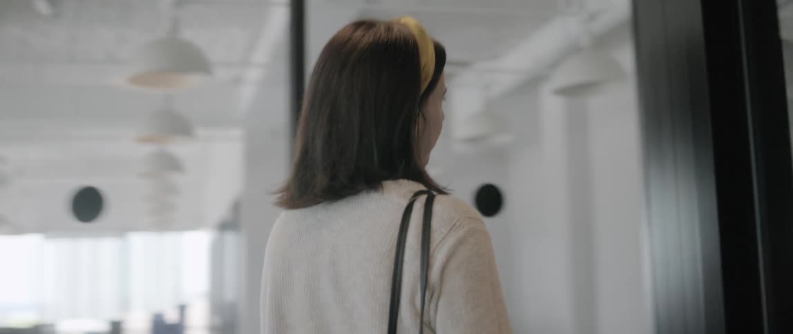 Woman walking through office hallway