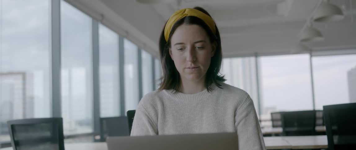 Woman working on a laptop in an office