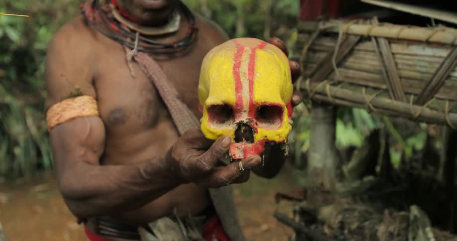 Man holds a painted skull