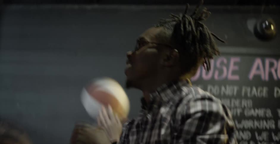 Two people playing basketball at an arcade