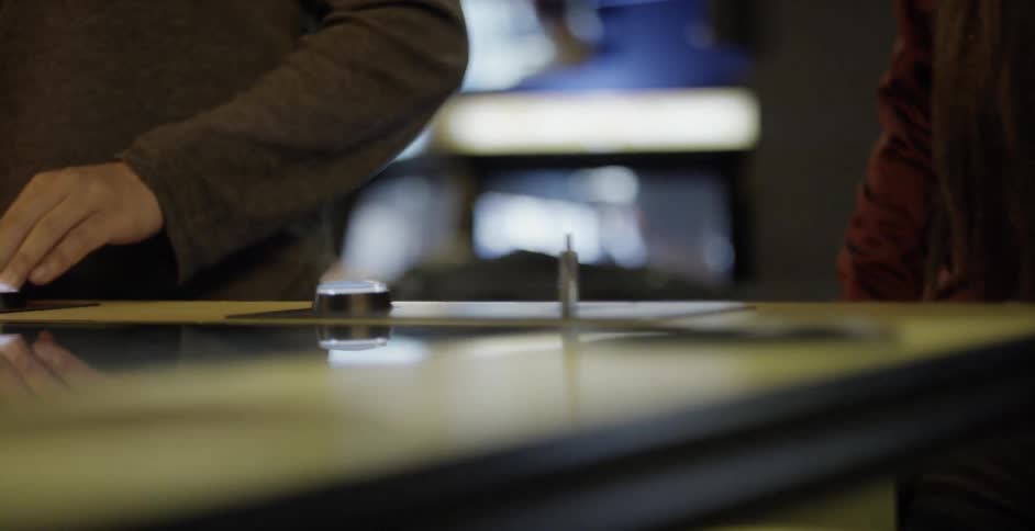 Two people playing on a video game machine