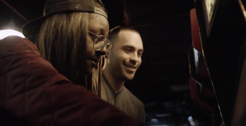 A man and a woman playing an arcade