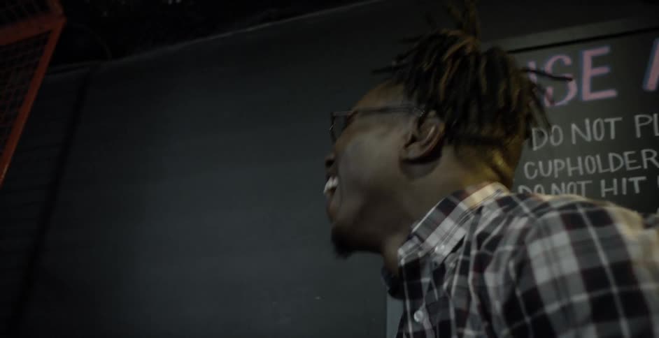 Young man shoots hoops into an arcade game