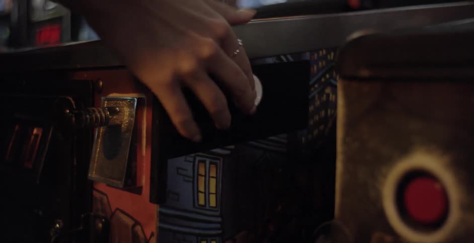 A person playing a pinball machine