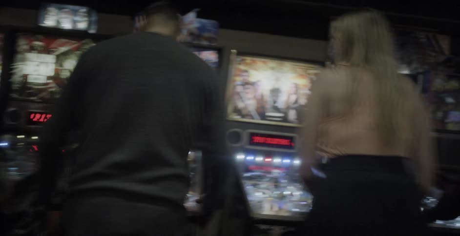 People playing ping pong in an arcade