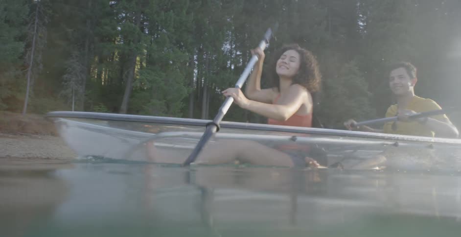 A man and woman paddle a canoe