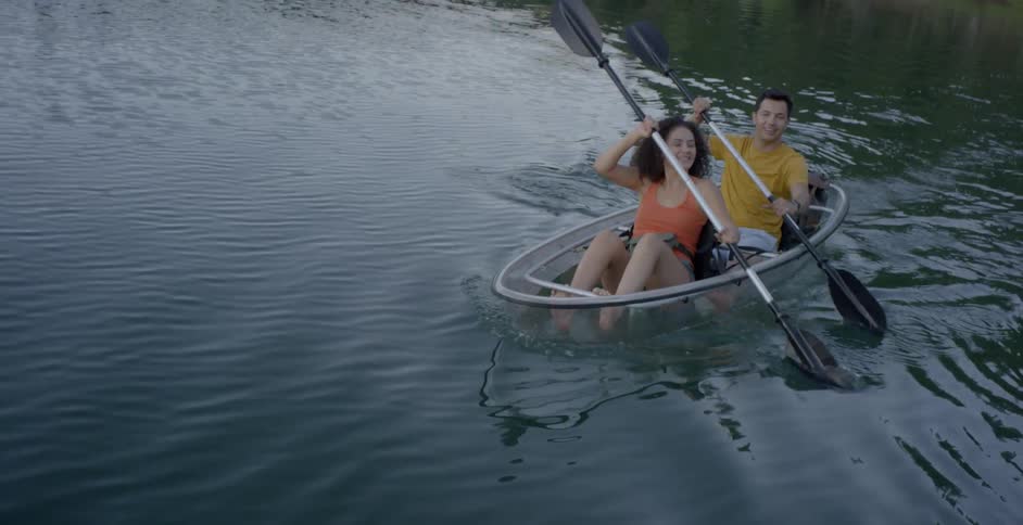 A man and woman rowing a boat on a lake