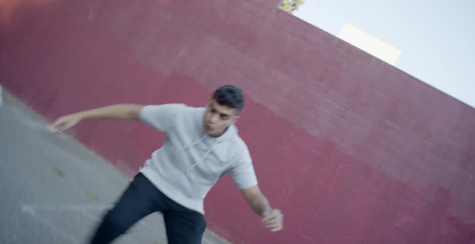 A person break dancing in a parking lot