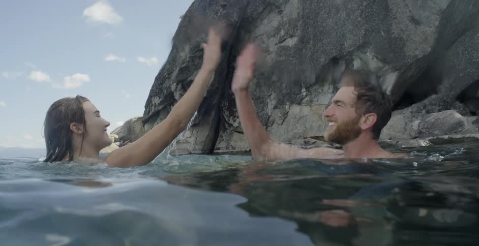 A man and woman that are swimming in the ocean