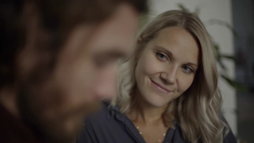 A woman staring at a man and smiling