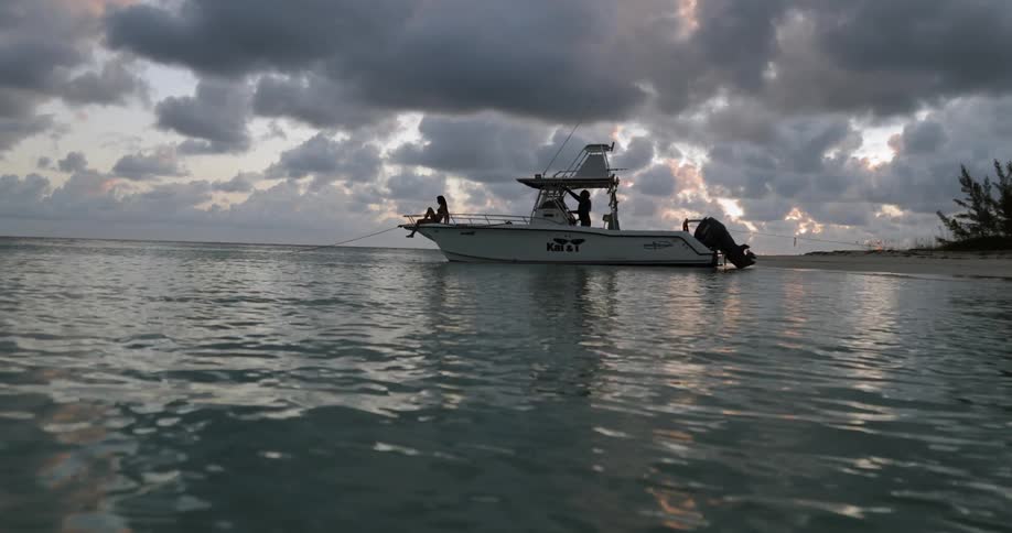 Woman and man on motor boat near shore