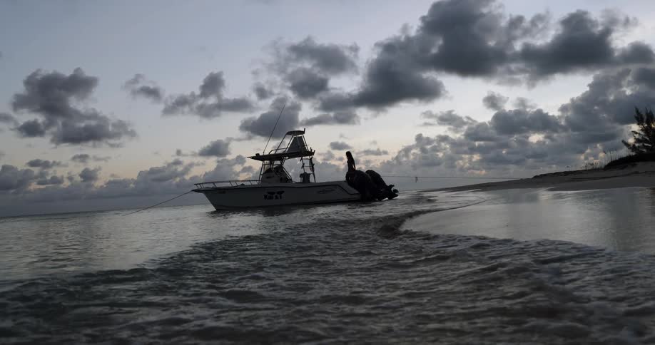 A woman walking on a boat on the shore