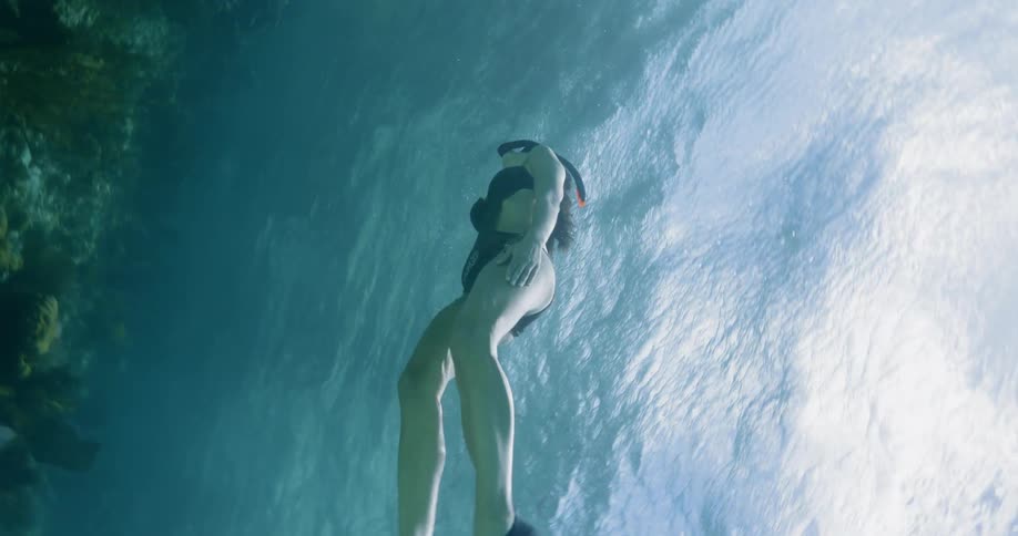 A young woman snorkels