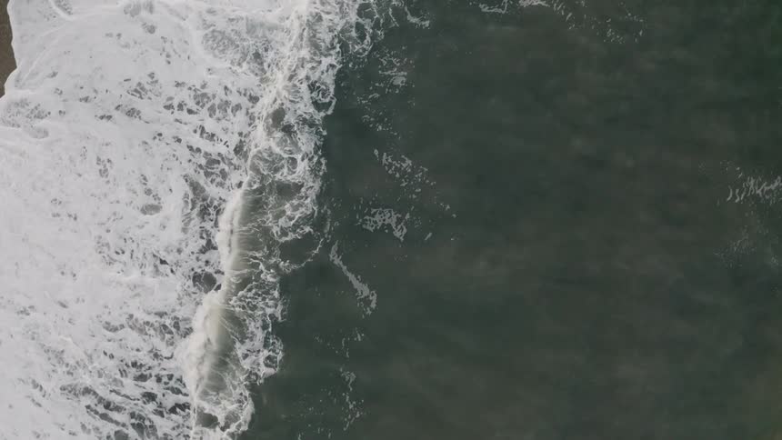Aerial view of waves crashing on a shore