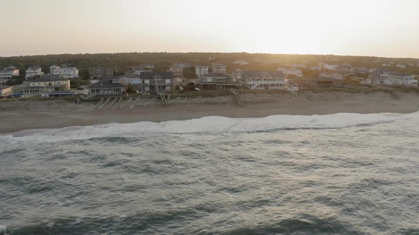 An aerial view of waves crashing on the beach