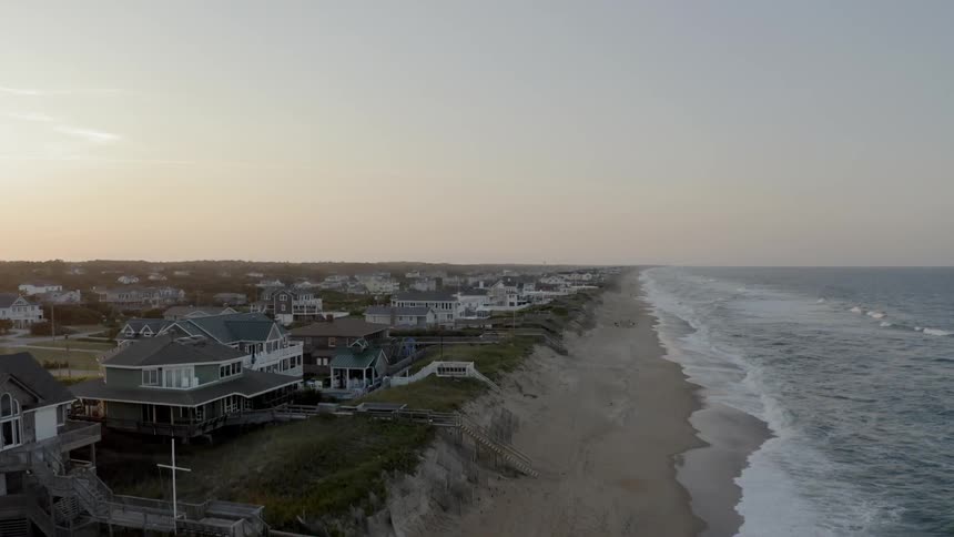 Houses close to the shore with the sky in the background