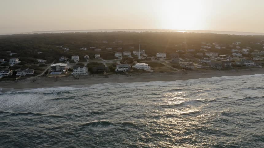Aerial view of coastal housing at sunrise