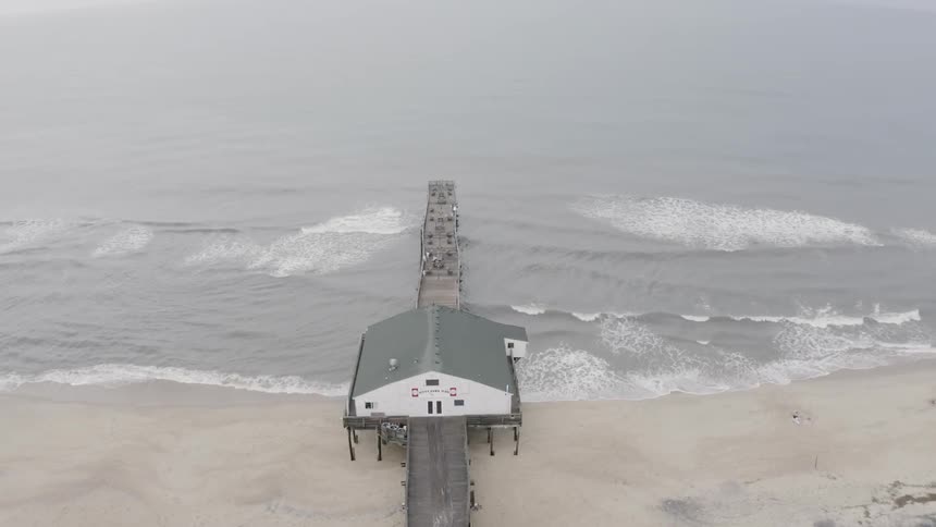Aerial view of pier on coast