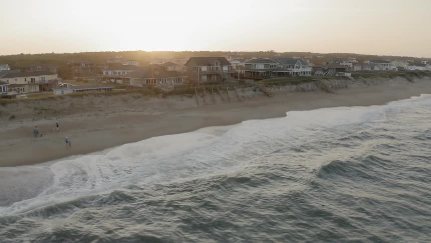Waves crashing on the shore line of a beach on the coast