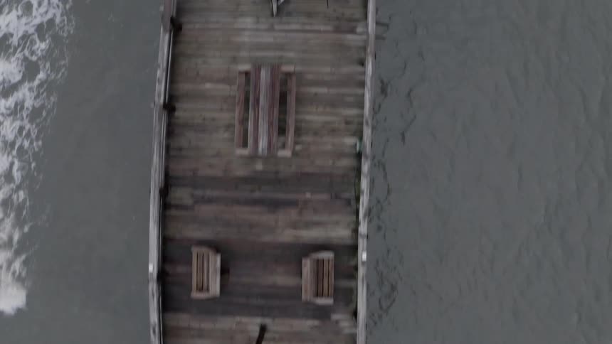 A long wooden pier extending out over the water