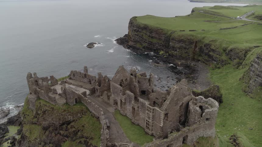 Aerial shot of an abandoned castle on top of cliffs