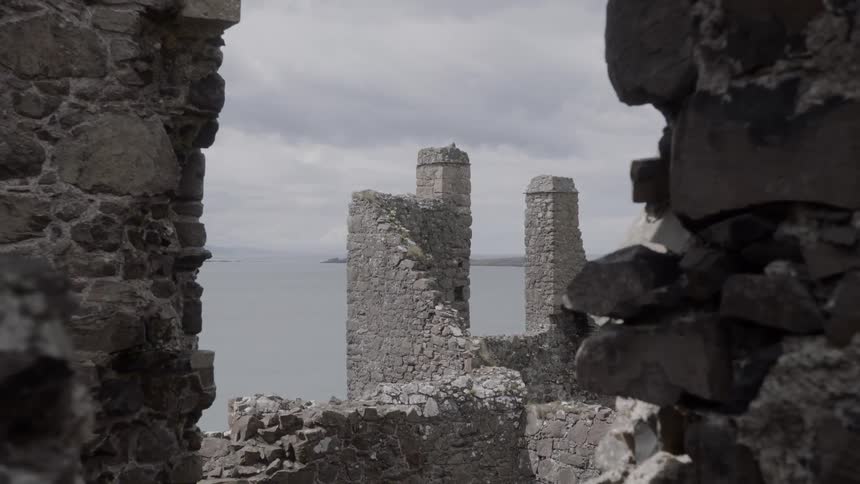 A ruined structure on a cliff next to the sea