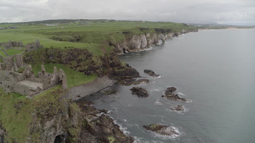 Flying over an old castle on the cliffs near the sea