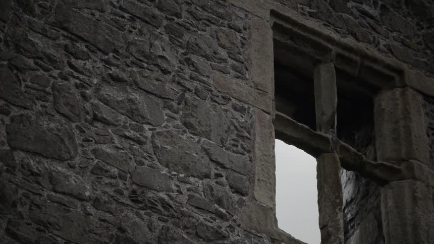 A window on a very old stone walled building in daylight