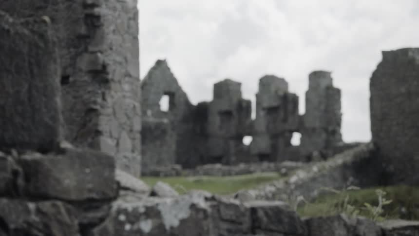 The ruins of a large structure on a cloudy day