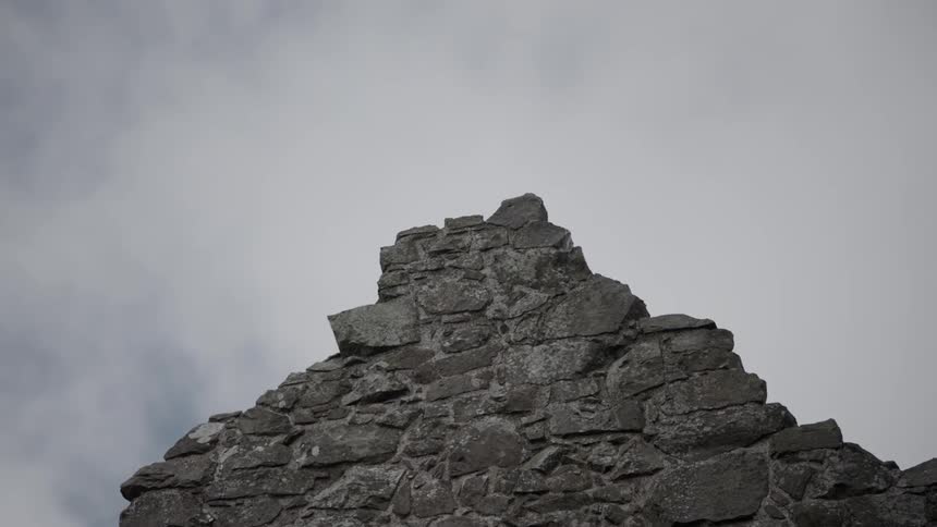 A ledge looking down on a field of clouds