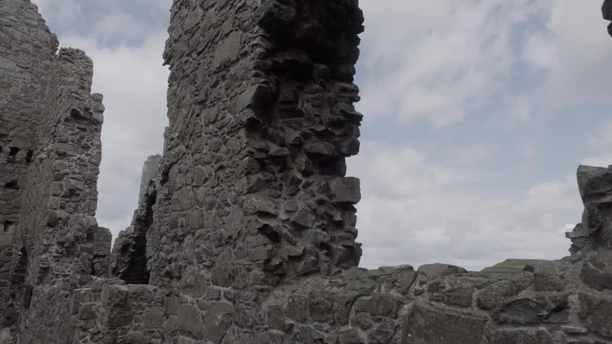 The partially stone standing walls of a large ancient monument on the coast