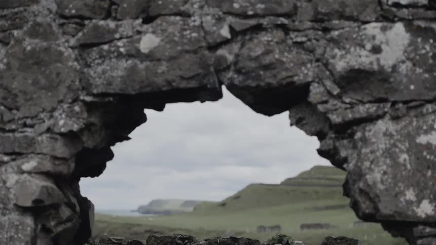 The view of hills between a rock arch