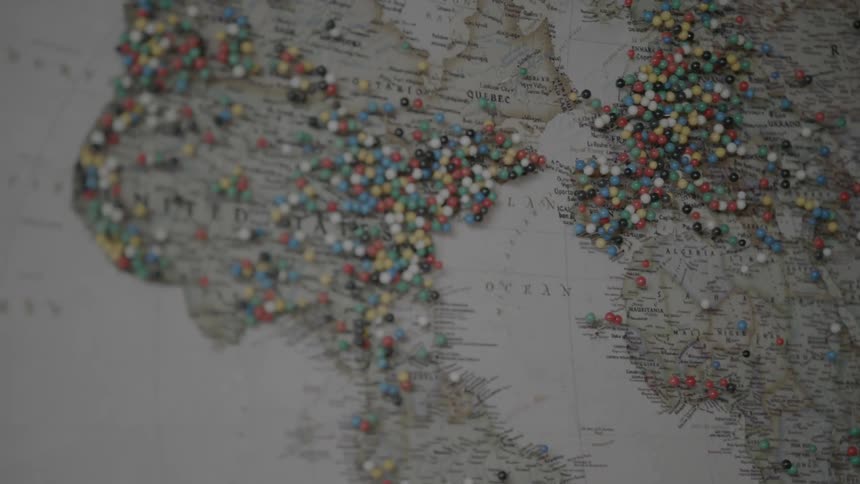 Hundreds of pins on a map of the world