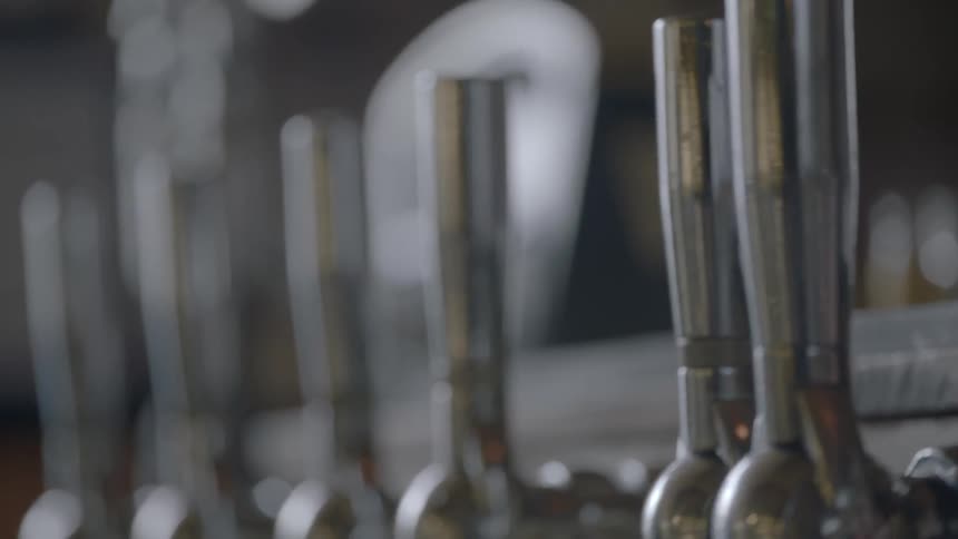 A row of beer pulls in a bar