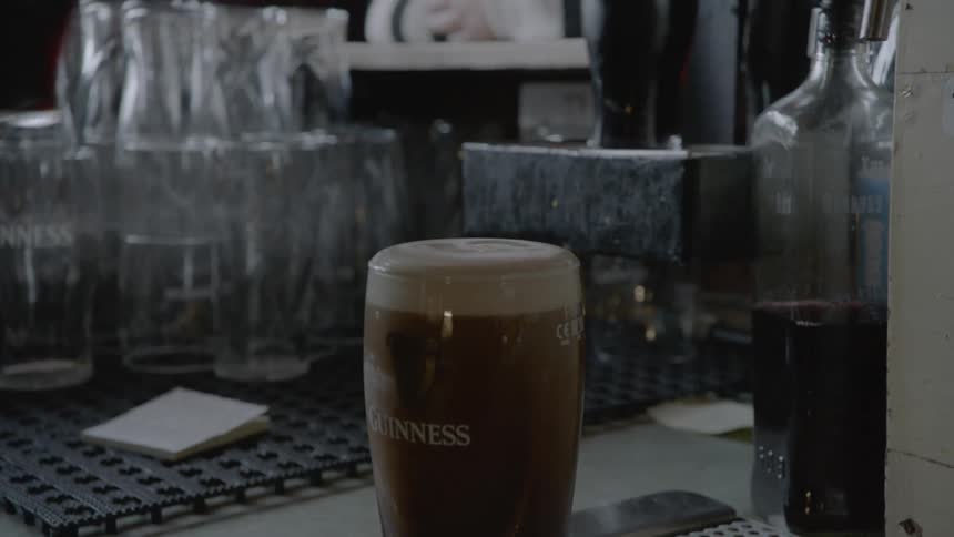 A person picks up glasses of beer