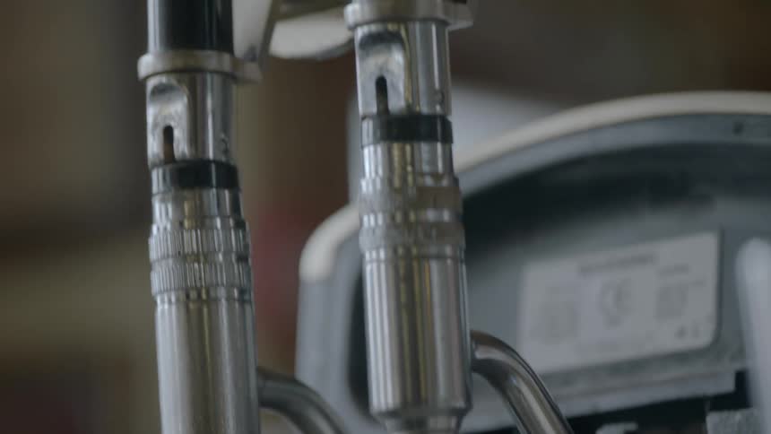 A pair of beer taps with a guinness glass hanging atop one lever