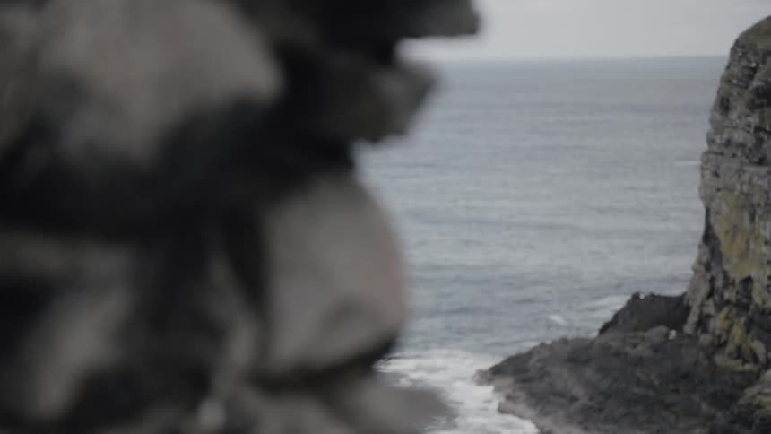 A rocky promontory and rolling waves