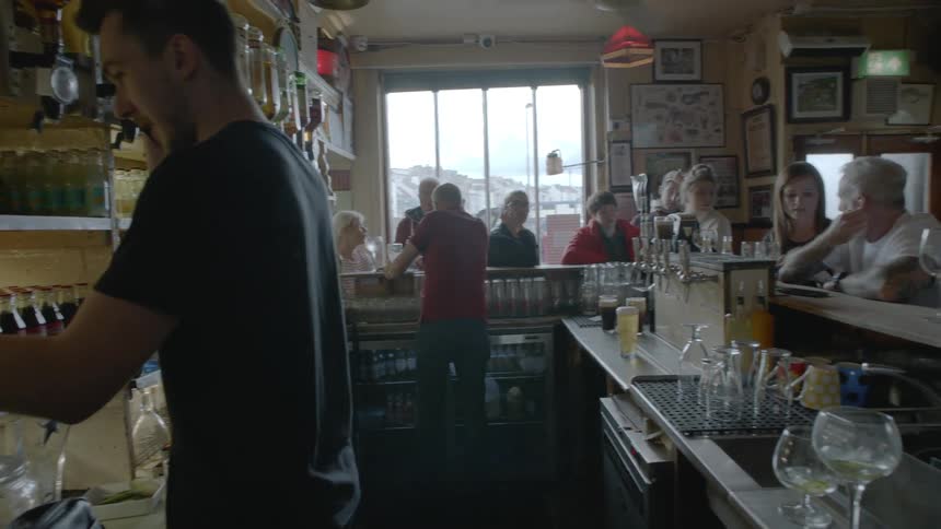 A group of people socializing at a bar