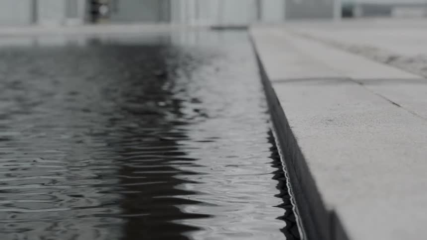 Rippling water at the edge of a pathway